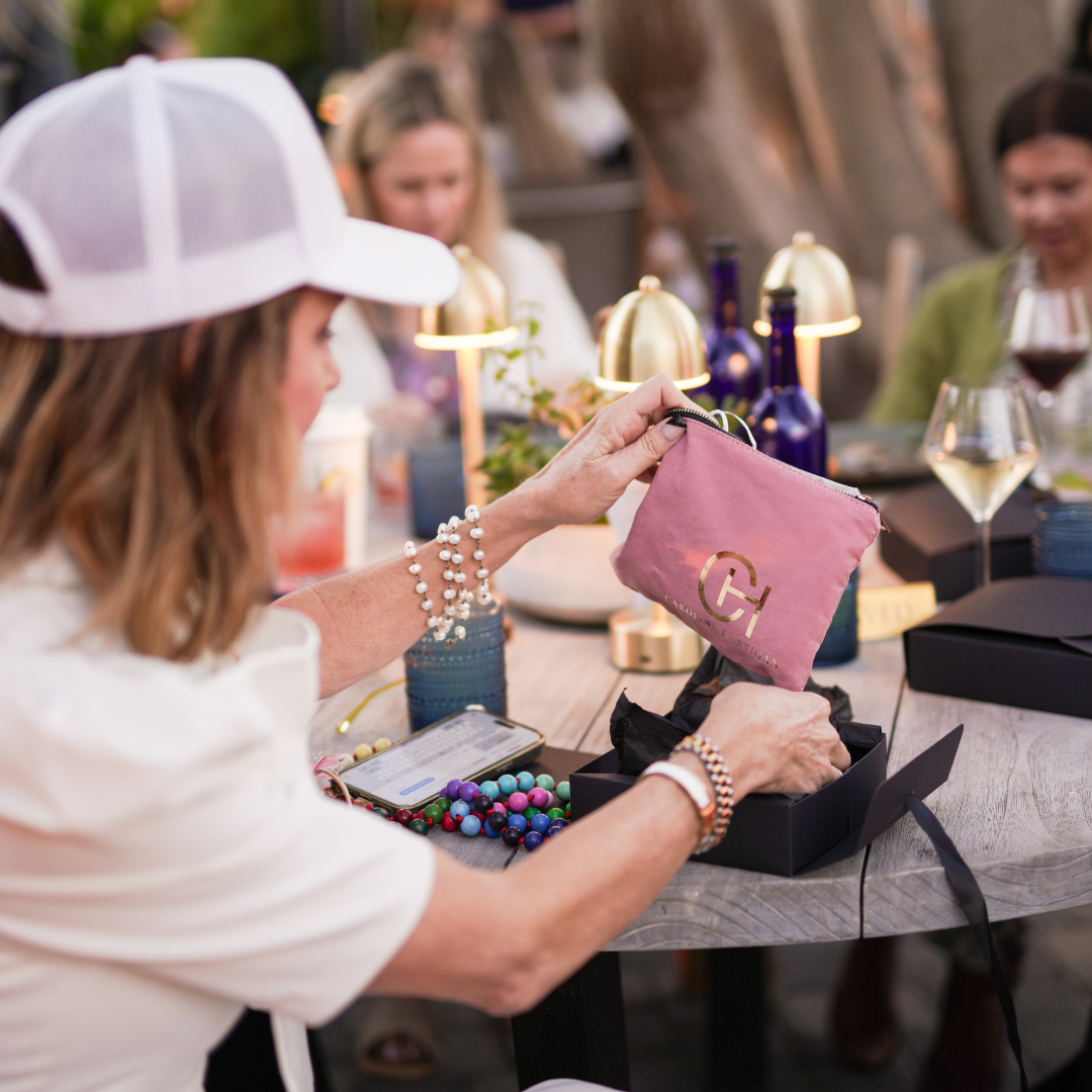 Women at event looking at pink bag